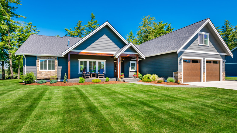 Craftsman,home,with,double,garage,lush,green,lawn,and,blue
